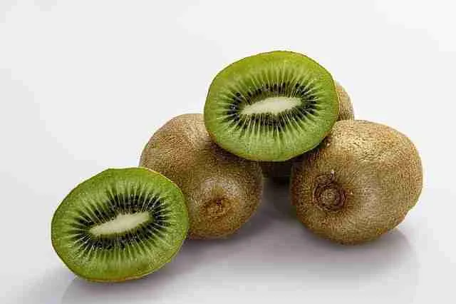 whole and cut kiwi fruit, showing the parts of the fruit
